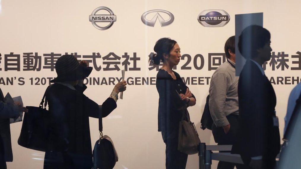 Shareholders arrive for Nissan's general meeting of shareholders in Yokohama, near Tokyo, Tuesday, June 25, 2019. Japanese automaker Nissan faces shareholders as profits and sales tumble after its former star chairman faces trial on financial misconduct allegations.(AP Photo/Koji Sasahara)