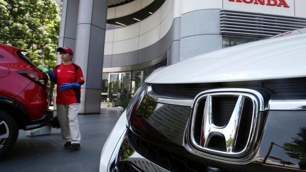 In this{&nbsp;} file photo, an employee of Honda Motor Co. cleans a Honda car displayed at its headquarters in Tokyo. Japanese automaker Honda Motor Co. is reporting Tuesday, Oct. 30, 2018, a 21 percent jump in fiscal second quarter profit on cost cuts and healthy motorcycle sales. (AP Photo/Koji Sasahara, File)