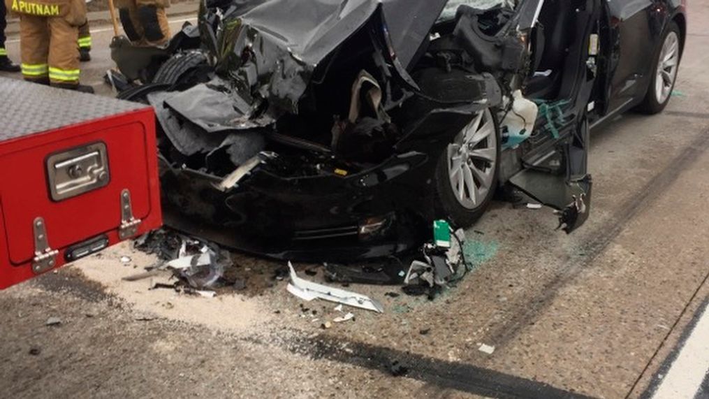 In this Friday, May 11, 2018, photo released by the South Jordan Police Department shows a traffic collision involving a Tesla Model S sedan with a Fire Department mechanic truck stopped at a red light in South Jordan, Utah. Witnesses indicated the Tesla Model S did not brake prior to impact. Police Sgt. Samuel Winkler said the car's air bags were activated and that the Tesla's 28-year-old driver suffered a broken right ankle, while the driver of the mechanic truck didn't require treatment. Police in a Salt Lake City suburb say it's not immediately known whether a Tesla Model S sedan's semi-autonomous Autopilot driving system was in use when it rear-ended a truck apparently without braking before impact at approximately 60 mph. (South Jordan Police Department via AP)