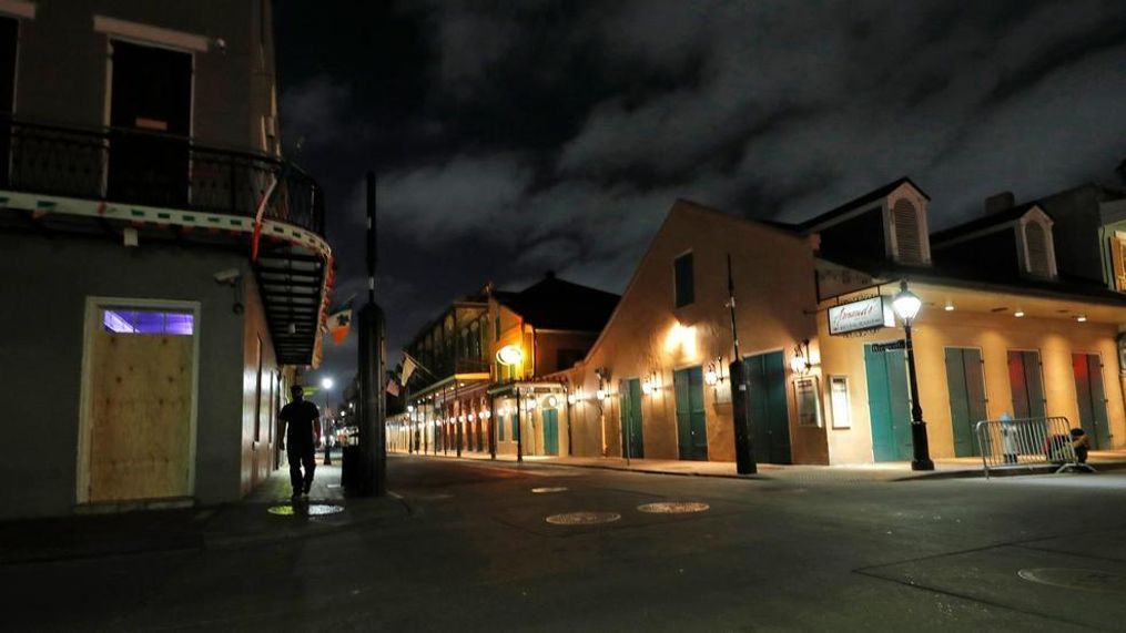 FILE - In this Thursday, March 19, 2020, file photo, a view of the nearly deserted Bourbon Street, which is normally bustling with tourists and revelers, is seen in the French Quarter of New Orleans. Like many cities around the country, New Orleans is currently under a shelter-in-place order as it grapples with a growing number of coronavirus cases. In Louisiana, Gov. John Bel Edwards has repeatedly sounded the alarm about how Louisiana has the third-highest rate of confirmed virus cases per capita while at the same time noting the difficulty of the small state getting supplies. (AP Photo/Gerald Herbert, File)