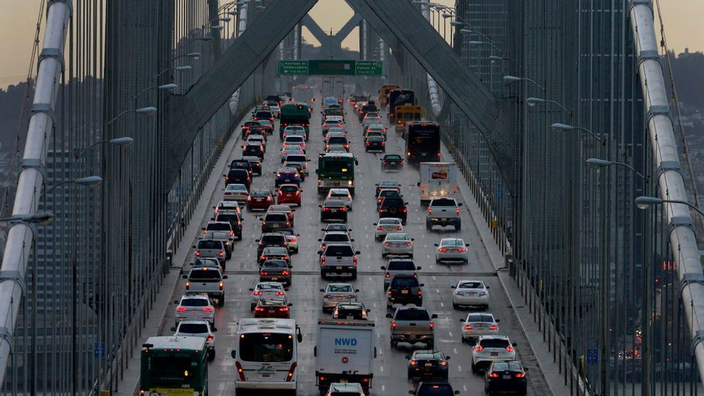 FILE - In this Dec. 10, 2015 file photo, vehicles make their way westbound on Interstate 80 across the San Francisco-Oakland Bay Bridge as seen from Treasure Island in San Francisco. California is telling automakers they must still comply with the state's strict vehicle mileage standards even if President Donald Trump rolls them back. The action Friday, Sept. 28, 2018, by the California Air Resources Board was widely expected. It sets up likely court battle if the Trump administration follows through with an attempt to revoke California's unique authority to set its own vehicle emissions standards. (AP Photo/Ben Margot, File)