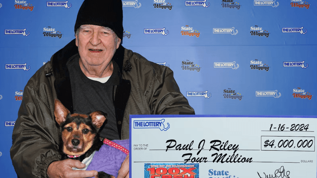 Paul Riley poses with his dog while accepting $4 million lottery prize (Massachusetts State Lottery)