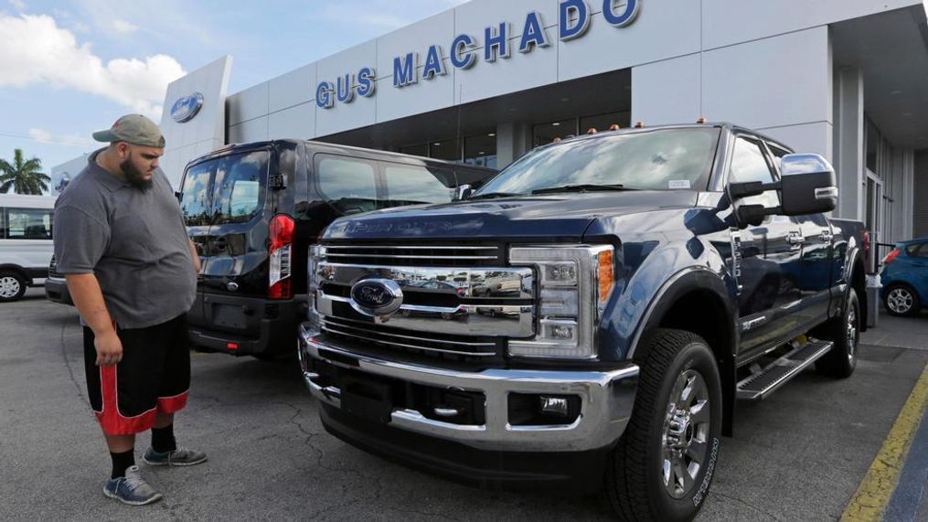 In this Tuesday, Jan. 17, 2017, file photo, a potential customer looks at a Ford F-250 Lariat FX4 at a Ford dealership, in Hialeah, Fla. Ford posted a big sales jump in October 2017 but Fiat Chrysler and General Motors reported declines as auto companies started to report numbers Wednesday, Nov. 1. The drop by two of the Detroit Three backs analysts’ expectations that September’s big gain in U.S. auto sales would fizzle in October. (AP Photo/Alan Diaz, File){p}{/p}