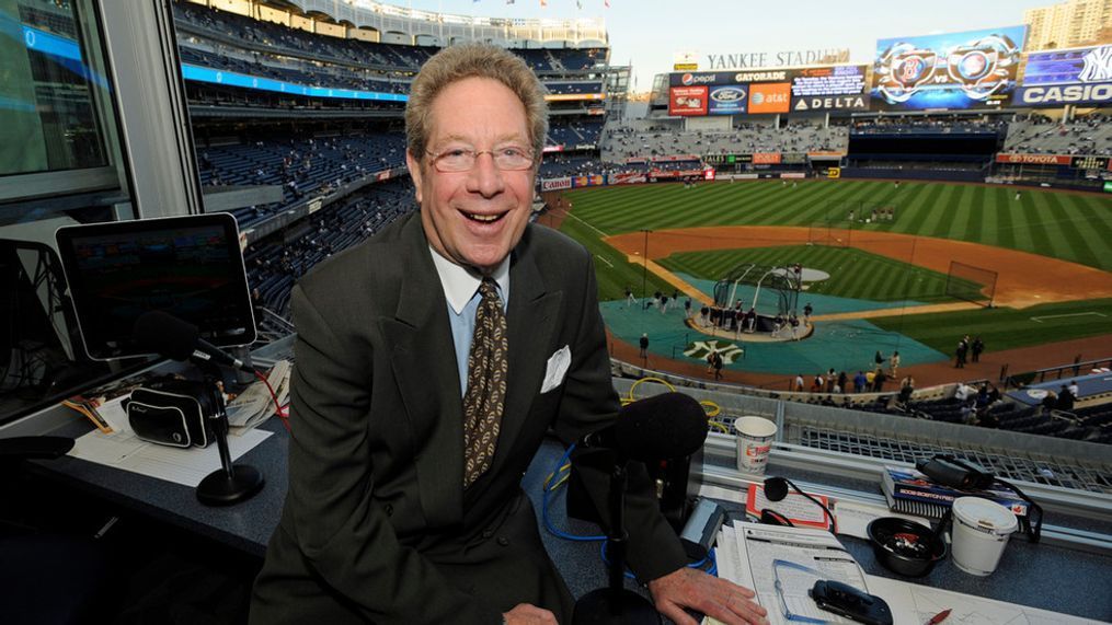 FILE - New York Yankees broadcaster John Sterling sits in his booth before a baseball game against the Boston Red Sox at Yankee Stadium in New York, Sept. 25, 2009. Sterling announced his immediate retirement Monday, April 15, 2024, at age 85 a few weeks into his 34th season in New York's broadcast booth. (AP Photo/Bill Kostroun, File)