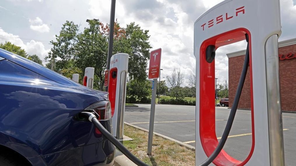 In this July 19, 2019, photo a Tesla vehicle charges at a Tesla Supercharger site in Charlotte, N.C. Tesla, Inc. reports earning on Wednesday, July 24, 2019. (AP Photo/Chuck Burton)