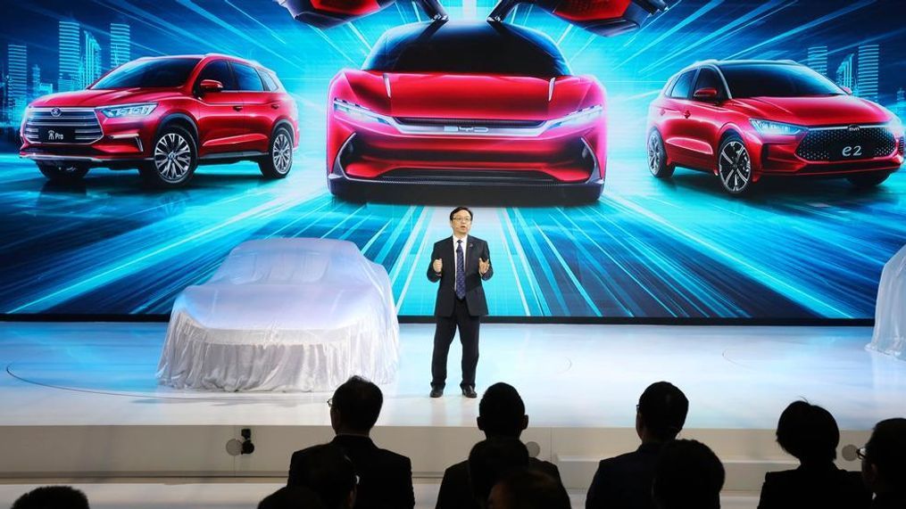 In this April 16, 2019, file photo, Wang Chuanfu, chairman and president of BYD Auto, the biggest global electric brand by sales volume, prepares to show the latest cars during the Auto Shanghai 2019 show in Shanghai. China’s auto sales fell 7.8% in June amid a trade fight with Washington and slower economic growth, extending a year-old contraction that is squeezing automakers that need to spend on developing electric cars. (AP Photo/Ng Han Guan, File)