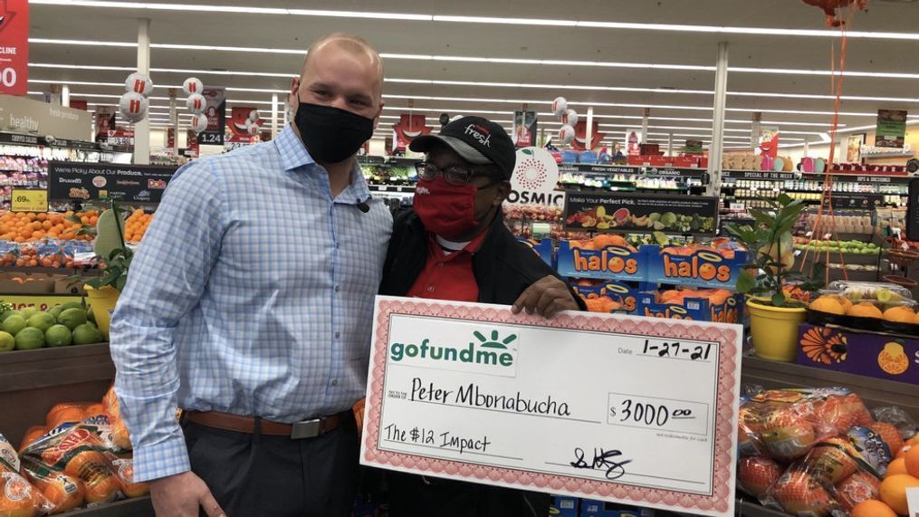 Sam Hammes (left) and Peter Mbonabuncha pose at the Oakland Road Hy-Vee on Wednesday, January 27, 2021. Hammes started a GoFundPage to thank Mbonabucha for helping him cover a grocery bill earlier in the month - and has since raised more than $3,000.