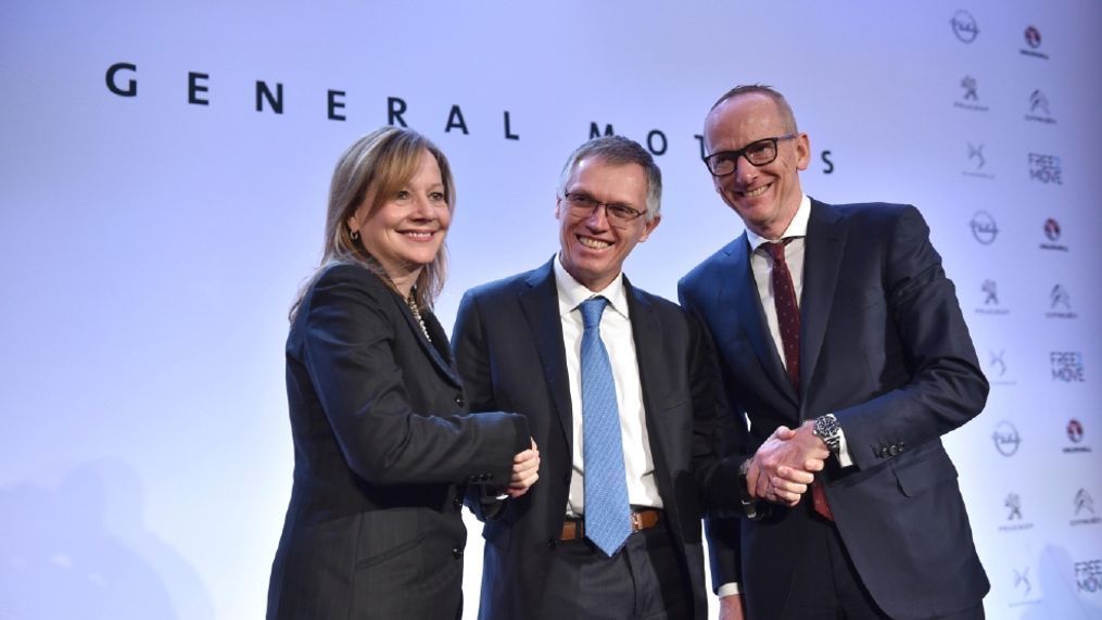 CEO of PSA Carlos Tavares, Opel CEO Karl-Thomas Neumann, right, and GM CEO Mary Barra, left, pose for photographers after addressing the media in Paris, France, Monday, March 6, 2017. General Motors is selling its loss-making European car business, including Germany's Opel and British brand Vauxhall, to France's PSA group in a deal that realigns the industry in the region. (AP Photo/Zacharie Scheurer)