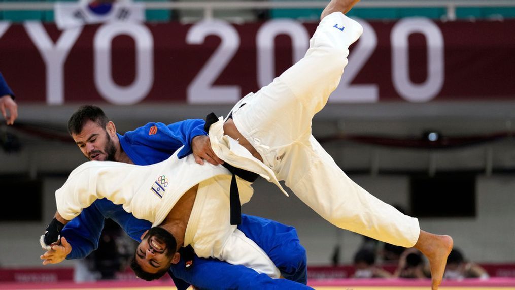 FILE  - Victor Sterpu of Moldova, background and Tohar Butbul of Israel compete during their men's -73kg round of 16 judo match at the 2020 Summer Olympics in Tokyo, Japan, Monday, July 26, 2021. (AP Photo/Vincent Thian, FIle)