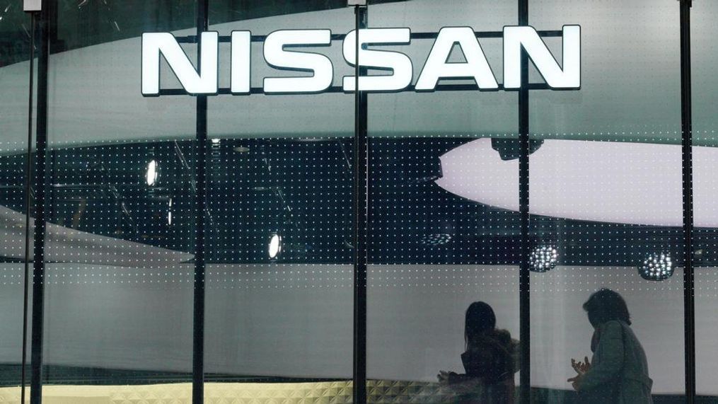 In this file photo, visitors walk near the logo of Nissan at a Nissan showroom in Tokyo. Nissan Motor Co. says it has received an inquiry from the U.S. Securities and Exchange Commission. The Japanese automaker said in a statement Monday, Jan. 28, 2019, that it "can confirm that we have received an inquiry from the SEC, and are cooperating fully. We cannot provide further details." (AP Photo/Eugene Hoshiko, File)