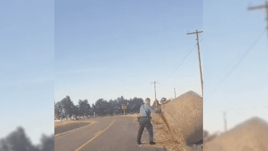 Trooper Isaiah Lemasters moves the hay bale. (Missouri State Highway Patrol.)