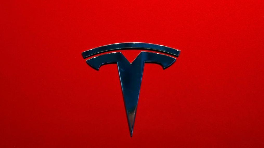 FILE- This Oct. 3, 2018, file photo shows the logo of Tesla model 3 at the Auto show in Paris. Tesla is increasing the size of its stock and debt offering to as much as $2.7 billion just one day after announcing plans to raise $2 billion in new capital. The Palo Alto, California, electric car and solar panel maker says it is increasing the offer due to the response from an announcement made Thursday, May 2, 2019. (AP Photo/Christophe Ena, File)