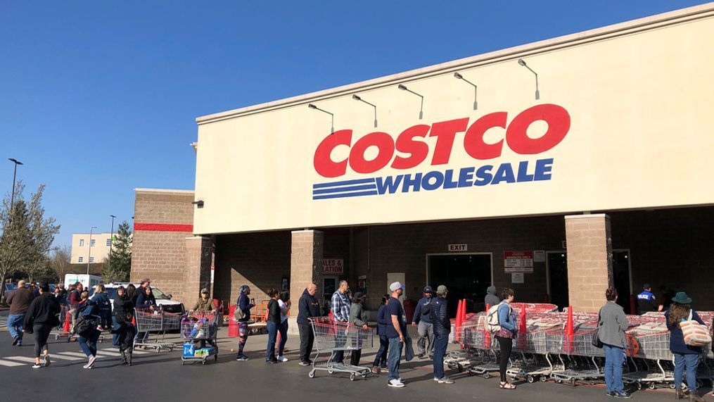 FILE - In this March 20, 2020 file photo, shoppers line up to enter a Costco store in Tacoma, Wash. (AP Photo/Ted S. Warren, Fle)