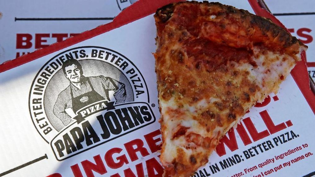 FILE- This Dec. 21, 2017, file photo shows a slice of cheese pizza at the Papa John's pizza shop in Quincy, Mass. Papa John’s plans to pull Schnatter’s image from marketing materials after reports he used a racial slur. Schnatter apologized Wednesday, July 11, and said he would resign as chairman after Forbes reported that he used the slur during a media training session. Schnatter had stepped down as CEO last year after criticizing NFL protests. (AP Photo/Charles Krupa, File)