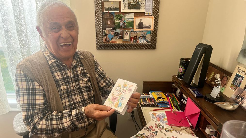 Hassan Salley proudly holds a card he created for a loved on. (WJAR)