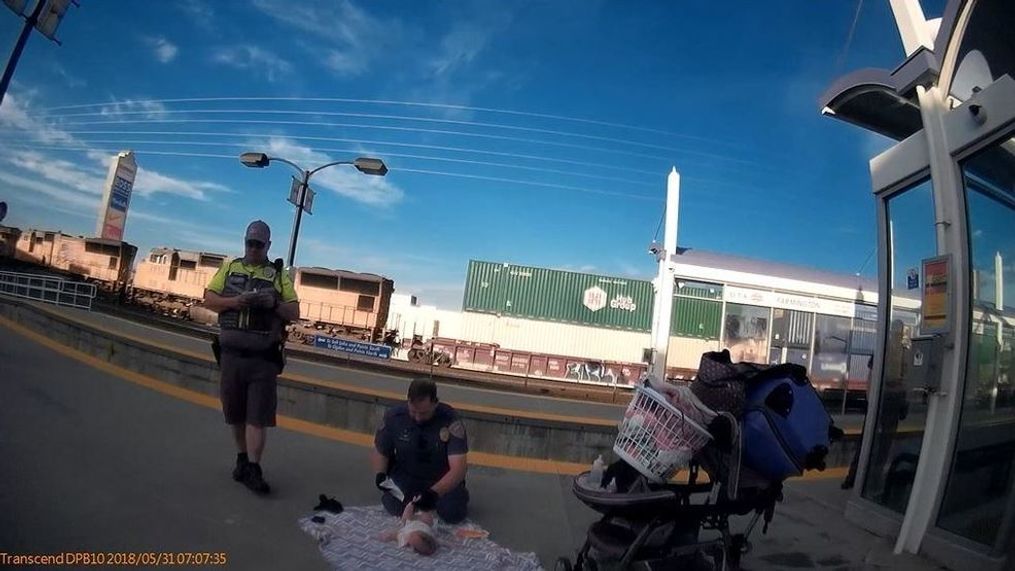 Farmington PD officer changes baby diaper. (Photo courtesy of Davis County Sheriff's Office)