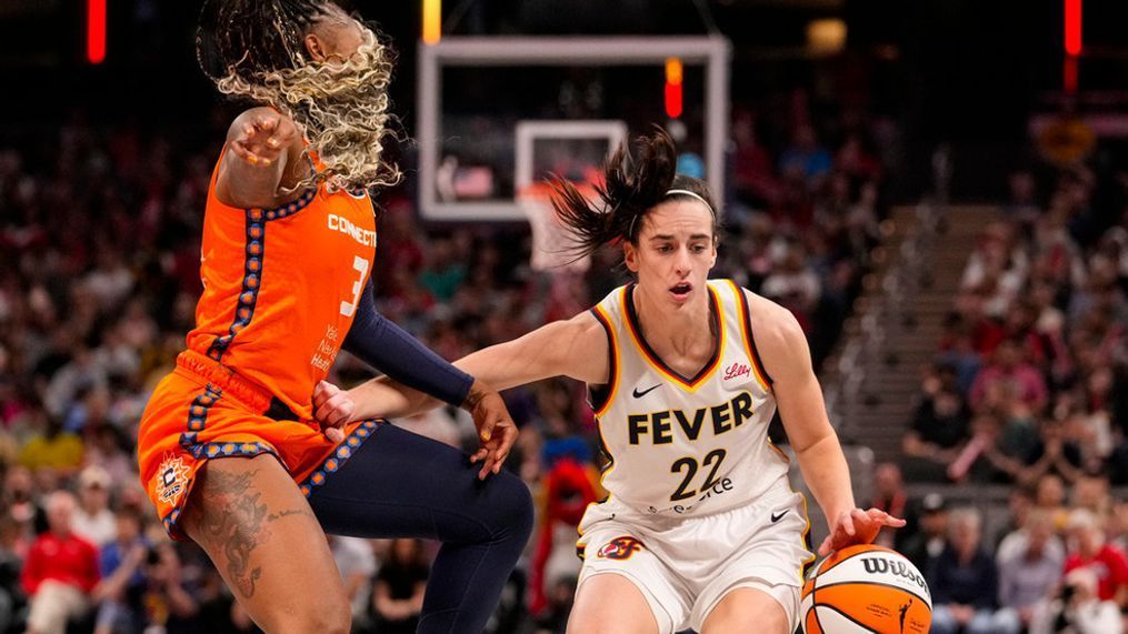 Indiana Fever guard Caitlin Clark (22) drives on Connecticut Sun guard Tiffany Mitchell (3) in the second half of a WNBA basketball game in Indianapolis, Monday, May 20, 2024. (AP Photo/Michael Conroy)