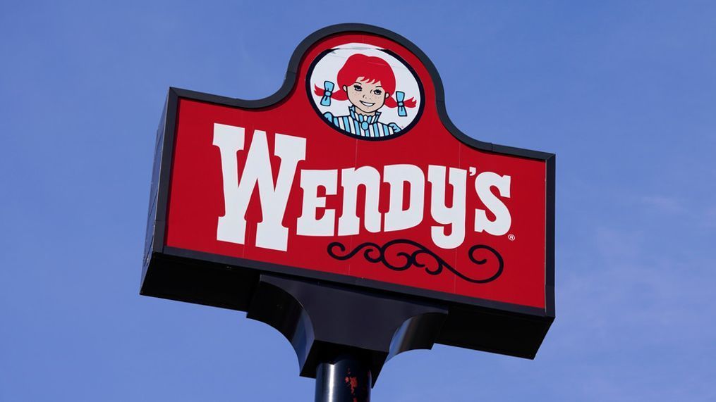 FILE - A sign stands over a Wendy's restaurant, Feb. 25, 2021, in Des Moines, Iowa. (AP Photo/Charlie Neibergall, File)