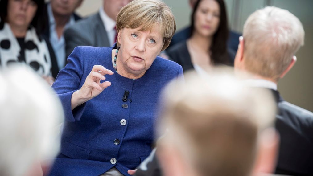 German chancellor  Angela Merkel  answers questions of TV journalist Michael Hirz, right, during a recording at TV broadcaster Phoenix in Berlin, Monday, Aug. 14, 2017.  (Michael Kappeler/dpa via AP)