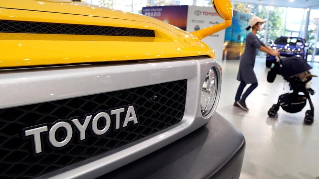 In this Nov. 13, 2017 photo, a visitor walks through at a Toyota showroom in Tokyo. Toyota Motor Corp. reported Tuesday, Feb. 6, 2018 an October-December profit of 941.8 billion yen ($8.6 billion), up from 486.5 billion yen the same period the previous year. (AP Photo/Koji Sasahara)