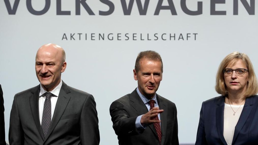 Herbert Diess, center, CEO of the Volkswagen stock company, and the members of the Board of Management of Volkswagen, Hiltrud Dorothea Werner, right, and Frank Witter, left, pose for the media prior to the shareholder's meeting in Berlin, Germany, Thursday, May 3, 2018. (AP Photo/Michael Sohn)