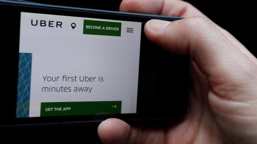 The Uber website is displayed on a phone in London, Friday, Sept. 22, 2017. London's transport authority said Friday it won't renew Uber's license to operate in the British capital, arguing that it demonstrates a lack of corporate responsibility with implications in public safety and security. (AP Photo/Kirsty Wigglesworth)