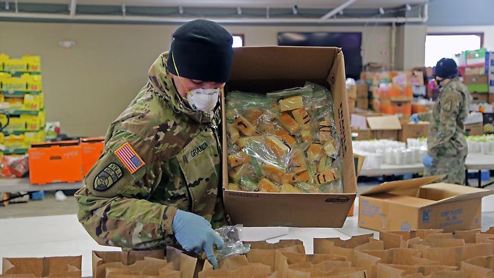 Alaska Army National Guard Soldier Sgt. Dylan Granza fills sack lunches at Bean's Cafe in Anchorage that will be distributed to thousands of Alaskans sheltering at Sullivan and Boeke arenas due to the COVID-19 pandemic, Apr. 8, 2020. Due to a shortage in volunteers amid the pandemic, these AKARNG Soldiers have rallied to help the local communities meet their needs(U.S. Army National Guard photo by Sgt. Seth LaCount/Released)