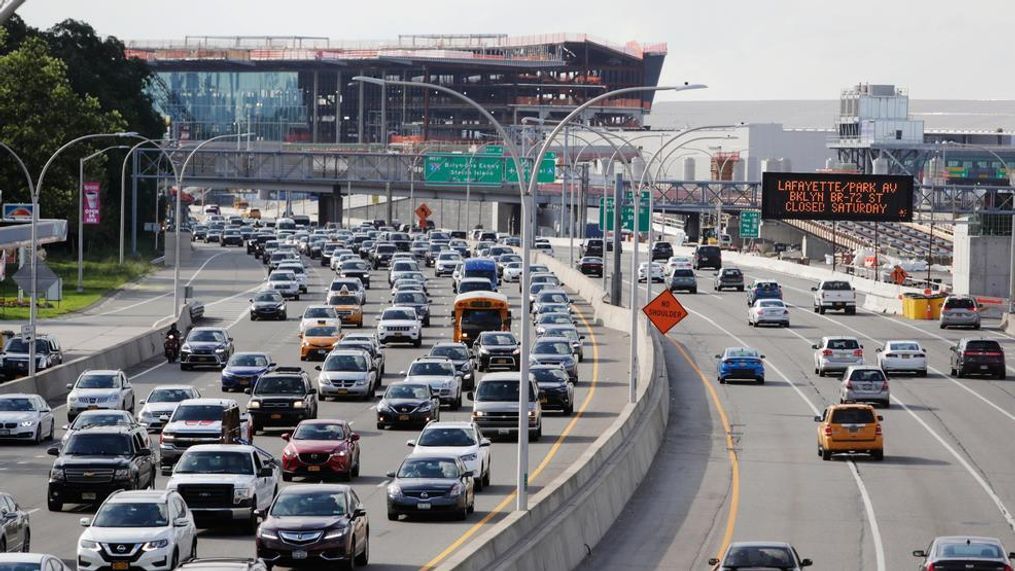 In this Aug. 1, 2018, photo, cars on the Grand Central Parkway pass LaGuardia Airport in New York. The Trump administration has proposed rolling back tougher Obama-era gas mileage requirements that are set to take effect after 2020. (AP Photo/Frank Franklin II)