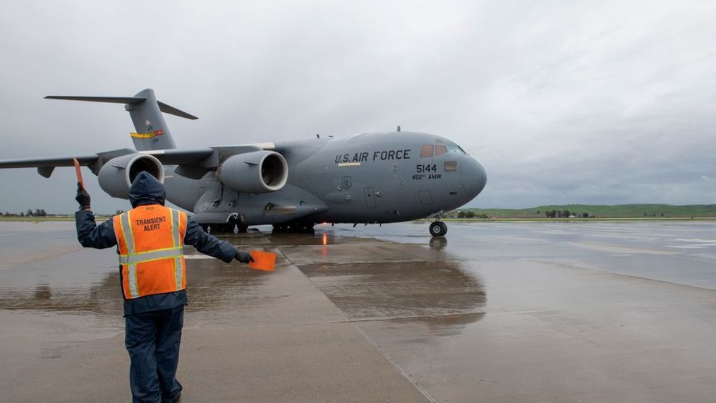 Jack Inman, a transient alert aircraft servicer, marshals a C-17 Globemaster III before takeoff April 5, 2020, at Travis Air Force Base, California. (U.S. Air Force photo by Tech. Sgt. James Hogman)