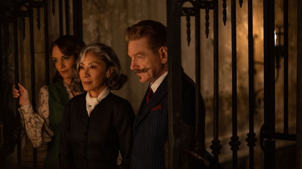 (L-R): Tina Fey as Ariadne Oliver, Michelle Yeoh as Mrs. Reynolds, and Kenneth Branagh as Hercule Poirot in 20th Century Studios' A HAUNTING IN VENICE. Photo by Rob Youngson. 2023 20th Century Studios. All Rights Reserved.