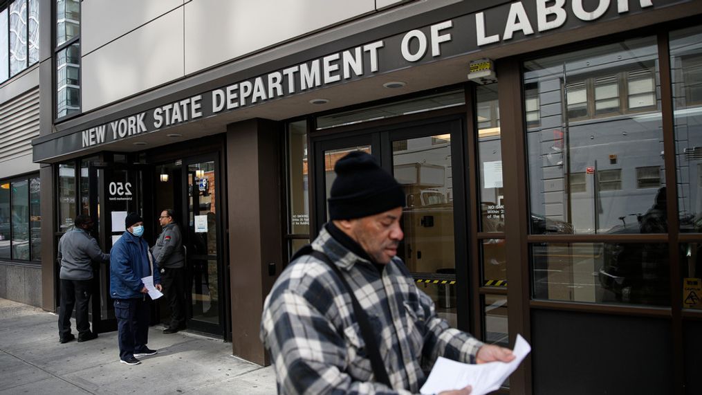 Visitors to the Department of Labor are turned away at the door by personnel due to closures over coronavirus concerns, Wednesday, March 18, 2020, in New York. (AP Photo/John Minchillo)