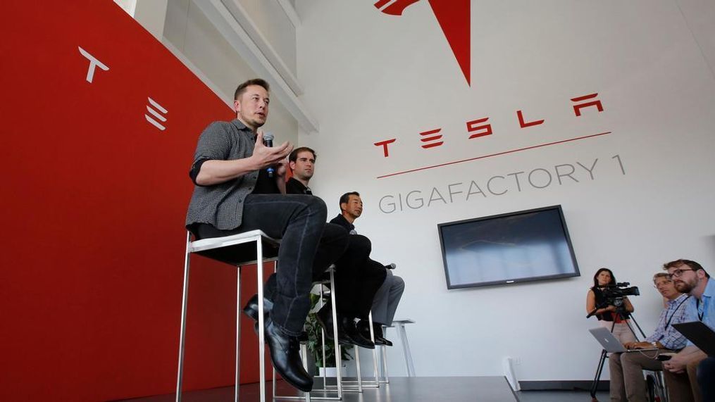 In this 2016 photo, Elon Musk, CEO of Tesla Motors Inc., left, discusses the company's new Gigafactory in Sparks, Nev. Tesla Inc. chief executive Musk is on track to deliver on a promise by building the world’s biggest lithium-ion battery in the Australian Outback within 100 days, an official said on Tuesday, Nov. 28, 2017. (AP Photo/Rich Pedroncelli, File){p}{/p}