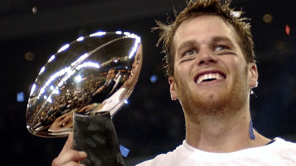 FILE - In this Feb. 1, 2004, file photo, New England Patriots quarterback Tom Brady holds the Vince Lombardi Trophy after the Patriots beat the Carolina Panthers 32-29 in Super Bowl 38 in Houston. (AP Photo/Dave Martin, File)