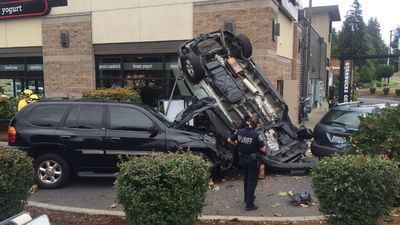 Image for story: Suspected impaired driver crashes car upside down into Starbucks drive-thru