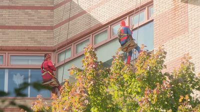 Image for story: Superheroes clean windows at children's hospital in Rhode Island