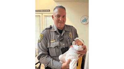 Image for story: New Jersey police officer reunites with baby girl he helped deliver