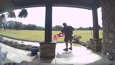 Image for story: Oklahoma UPS driver fixes rolled up American flag 