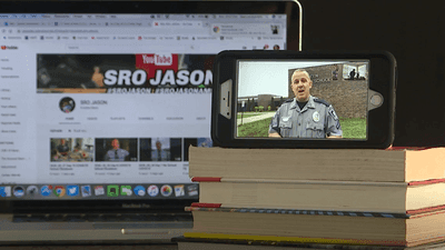 Image for story: Staying connected: A school police officer helping students find lessons and free meals