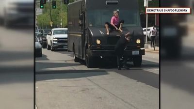 Image for story: Caught on camera: Woman on top of delivery truck hits man with windshield wiper