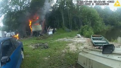 Image for story:  VIDEO: Cops risk lives to save 2 trapped dogs near burning trailer