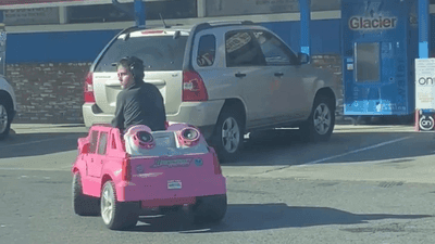 Image for story: VIDEO: Young boy pulls up to store in pink battery-powered toy car