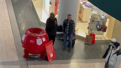 Image for story: WATCH: Stranger joins Salvation Army bell ringer to sing Christmas carol at New York mall