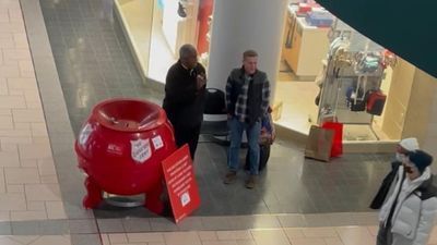 Image for story: WATCH: Stranger joins Salvation Army bell ringer to sing Christmas carol at New York mall