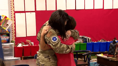 Image for story: Mother returns from deployment, surprises her 2 kids at school