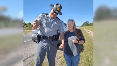 Image for story: Slithering surprise: SC troopers remove snake from woman's car