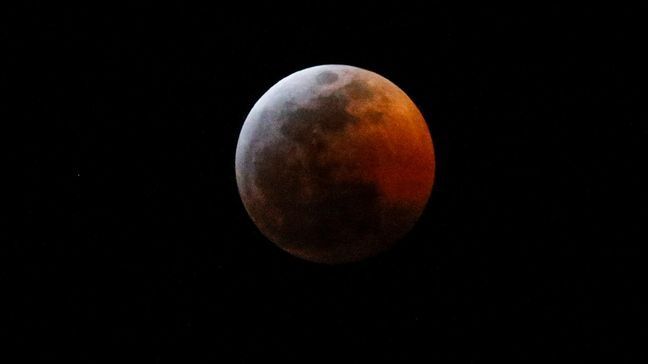 FILE - This photo shows the moon during a total lunar eclipse, seen from Los Angeles, Sunday Jan. 20, 2019. (AP Photo/Ringo H.W. Chiu)