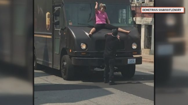 A still from a video showing a woman hitting a man with a windshield wiper of a UPS truck on Branch Avenue in Providence. (Courtesy of Demetrius Shavoo Flenory)