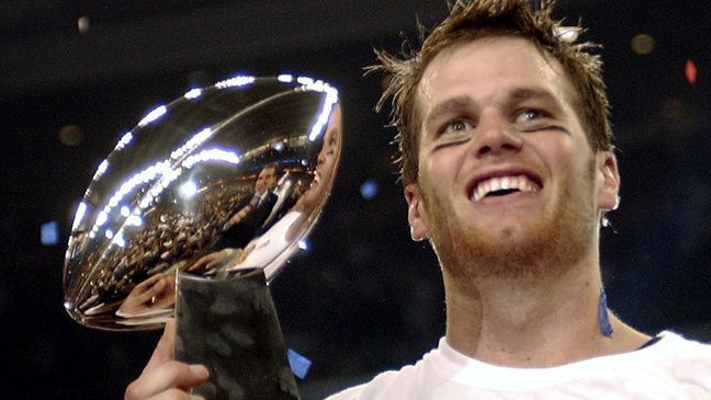 FILE - In this Feb. 1, 2004, file photo, New England Patriots quarterback Tom Brady holds the Vince Lombardi Trophy after the Patriots beat the Carolina Panthers 32-29 in Super Bowl 38 in Houston. Brady, who won a record seven Super Bowls for New England and Tampa, has announced his retirement, Wednesday, Feb. 1, 2023.  (AP Photo/Dave Martin, File)