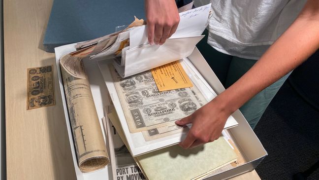 The Saugatuck-Douglas Historical Center archives house several photographs, artifacts and newspaper clippings from the buried town of Singapore, Michigan. (Photo: WWMT/Will Haenni)