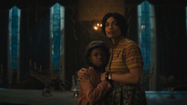 (L-R): Chase Dillon as Travis and Rosario Dawson as Gabbie in Disney's live-action HAUNTED MANSION. Photo courtesy of Disney. Â© 2023 Disney Enterprises, Inc. All Rights Reserved.